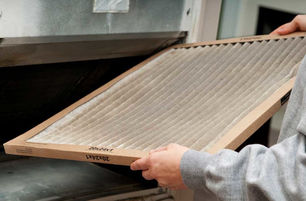 a man changeing an HVAC air conditioning filter